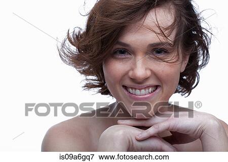 Stock Photo - Young woman with hands on chin. Fotosearch