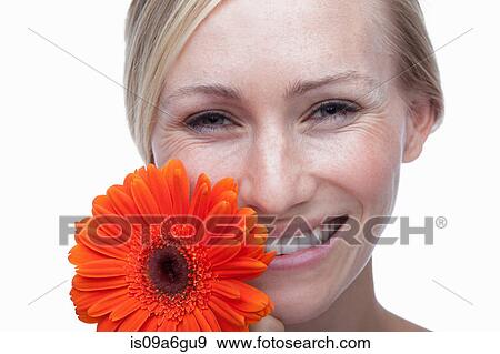 Young woman with orange flower View Large Photo Image Stock Photo - Young woman with orange flower. Fotosearch