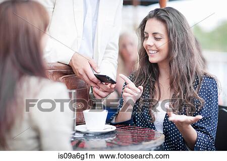 Young women in cafe View Large Photo Image Picture - Young women in cafe. Fotosearch