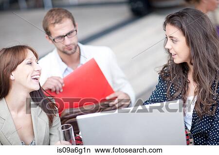 Young women using laptop in cafe View Large Photo Image Picture - Young women using laptop in cafe. Fotosearch