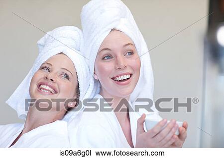 Young women wearing towels on heads with teacup View Large Photo Image Stock Image - Young women wearing towels on heads with teacup. Fotosearch