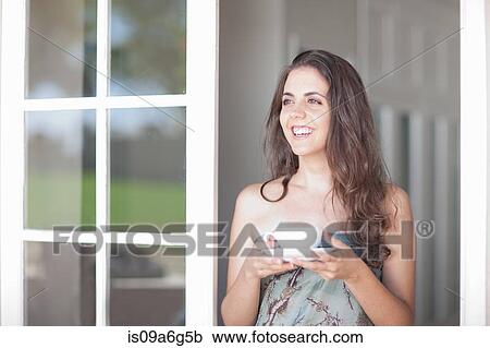 Stock Image - Young women with cup of tea. Fotosearch