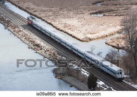 Stock Photography - Aerial view of train travelling though countryside. Fotosearch