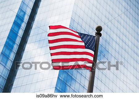 American flag against skyscraper View Large Photo Image Stock Photo - American flag against skyscraper. Fotosearch