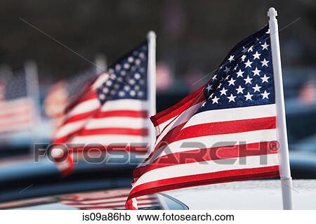 Stock Image - American flags on car roof. Fotosearch