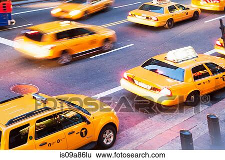 Angular view of yellow cabs on the go New York City, USA View Large Photo Image Stock Photograph - Angular view of yellow cabs on the go New York City, USA. Fotosearch
