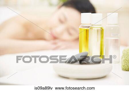 Aromatherapy oils with woman in background View Large Photo Image Stock Photo - Aromatherapy oils with woman in background. Fotosearch
