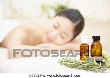 Aromatherapy oils with woman in background View Large Photo Image Stock Photo - Aromatherapy oils with woman in background. Fotosearch
