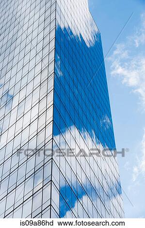 Blue cloudy sky reflected in windows of modern skyscraper View Large Photo Image Stock Image - Blue cloudy sky reflected in windows of modern skyscraper. Fotosearch