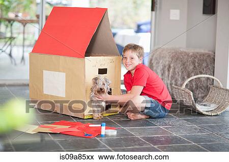 Boy building kennel for his dog View Large Photo Image Stock Photo - Boy building kennel for his dog. Fotosearch
