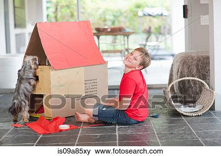 Boy building kennel for his dog View Large Photo Image Stock Photo - Boy building kennel for his dog. Fotosearch