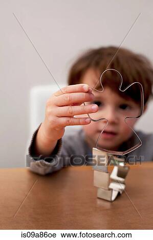 Boy looking through Christmas cookie cutters View Large Photo Image Stock Image - Boy looking through Christmas cookie cutters. Fotosearch