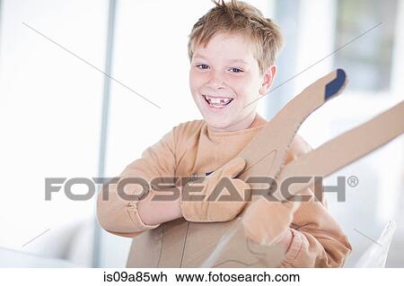 Boy playing the guitar View Large Photo Image Stock Image - Boy playing the guitar. Fotosearch