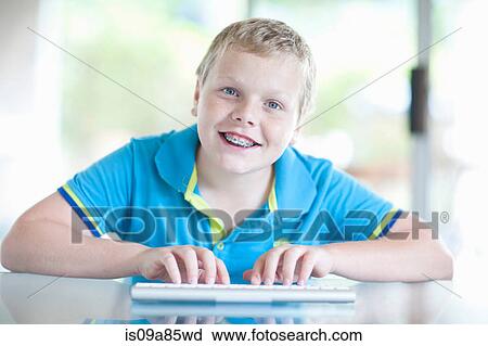 Boy using digital tablet View Large Photo Image Stock Image - Boy using digital tablet. Fotosearch