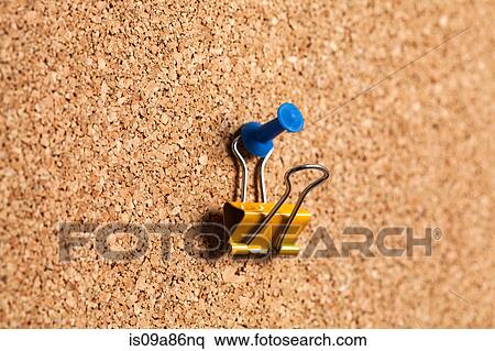 Bulldog clip hanging on corkboard View Large Photo Image Stock Photography - Bulldog clip hanging on corkboard. Fotosearch