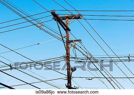 Cables attached to telegraph pole against blue sky View Large Photo Image Picture - Cables attached to telegraph pole against blue sky. Fotosearch