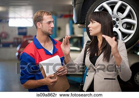 Car mechanic and customer discussing car repair View Large Photo Image Stock Photography - Car mechanic and customer discussing car repair. Fotosearch
