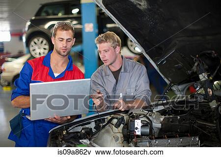 Car mechanics discussing and analyzing car repair View Large Photo Image Stock Photo - Car mechanics discussing and analyzing car repair. Fotosearch
