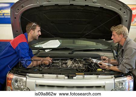 Car mechanics discussing and analyzing car repair View Large Photo Image Stock Photo - Car mechanics discussing and analyzing car repair. Fotosearch