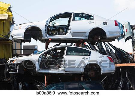 Cars stacked in scrap yard View Large Photo Image Stock Photo - Cars stacked in scrap yard. Fotosearch