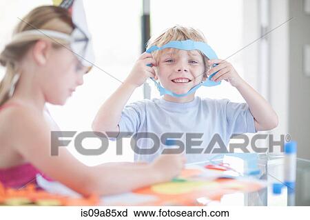 Stock Image - Children's mask making party. Fotosearch