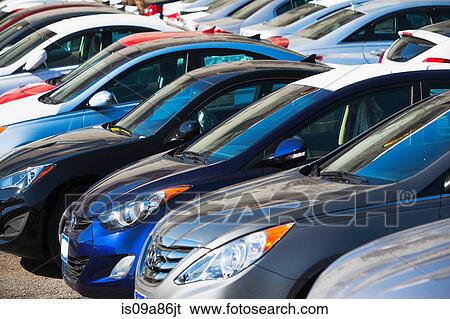 Close up of cars in parking lot View Large Photo Image Stock Photograph - Close up of cars in parking lot. Fotosearch