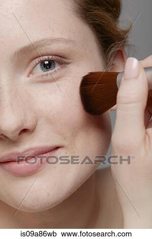 Close up of part of young woman's face, applying make up View Large Photo Image Stock Image - Close up of part of young woman's face, applying make up. Fotosearch