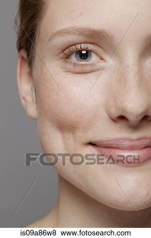 Stock Photo - Close up of part of young woman's face, smiling. Fotosearch