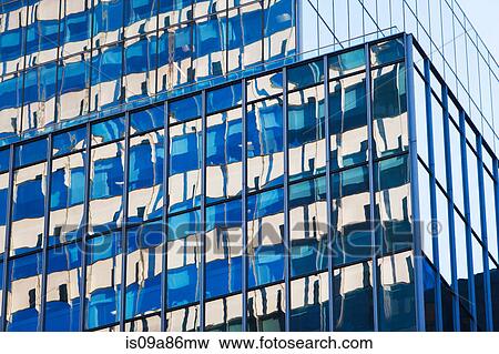 Stock Photo - Close up of skyscraper with glass facades. Fotosearch