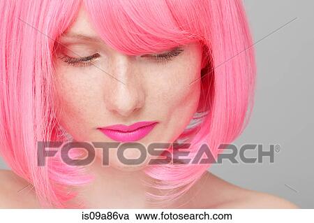 Stock Image - Close up of teenage girl with pink hair. Fotosearch