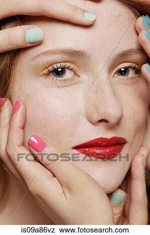 Close up of young woman with hands around her face View Large Photo Image Stock Photo - Close up of young woman with hands around her face. Fotosearch