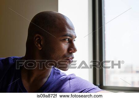 Close up portrait of mid adult male looking out of window View Large Photo Image Stock Image - Close up portrait of mid adult male looking out of window. Fotosearch