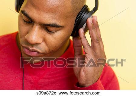 Close up portrait of mid adult male eyes closed using headphones View Large Photo Image Stock Photo - Close up portrait of mid adult male eyes closed using headphones. Fotosearch