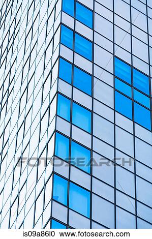 Stock Image - Corner detail of office building with glass facade. Fotosearch