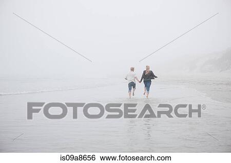 Couple running on beach View Large Photo Image Stock Photograph - Couple running on beach. Fotosearch