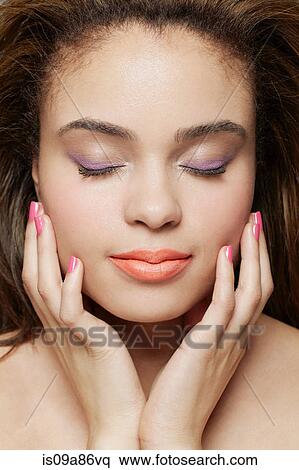 Cropped shot of young woman wearing make up View Large Photo Image Stock Photography - Cropped shot of young woman wearing make up. Fotosearch