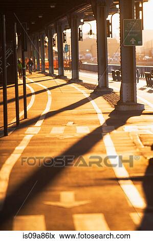 Stock Photo - Cycle route below bridge at sunset New York City, USA. Fotosearch