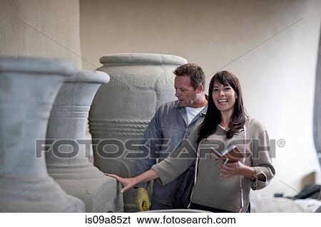 Stock Photograph - Dealing with sales in pottery factory. Fotosearch