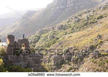 Distant view of young man with mountain bike on rock View Large Photo Image Stock Image - Distant view of young man with mountain bike on rock. Fotosearch