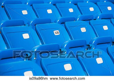Empty blue seating in sports stadium View Large Photo Image Picture - Empty blue seating in sports stadium. Fotosearch