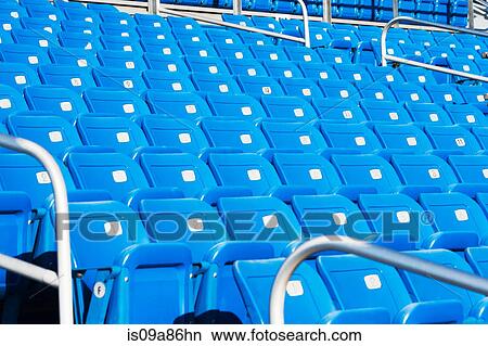 Empty blue seating in sports stadium View Large Photo Image Picture - Empty blue seating in sports stadium. Fotosearch