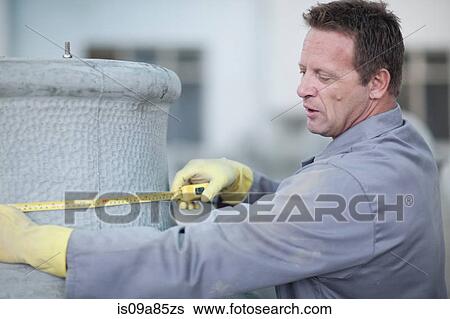 Factory worker measuring a large vase View Large Photo Image Stock Photograph - Factory worker measuring a large vase. Fotosearch