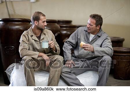 Stock Image - Factory worker taking a break. Fotosearch