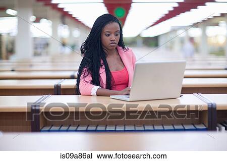 Female student studying in library View Large Photo Image Stock Image - Female student studying in library. Fotosearch