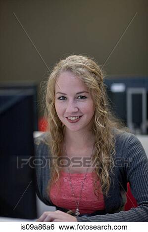 Stock Photograph - Female student using computer in class. Fotosearch