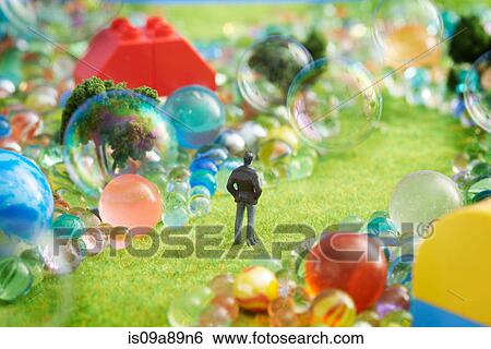Figurine on pretend grass with marbles View Large Photo Image Stock Photograph - Figurine on pretend grass with marbles. Fotosearch