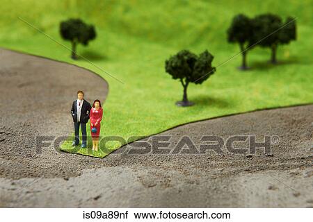 Stock Image - Figurines on pretend grass with trees. Fotosearch