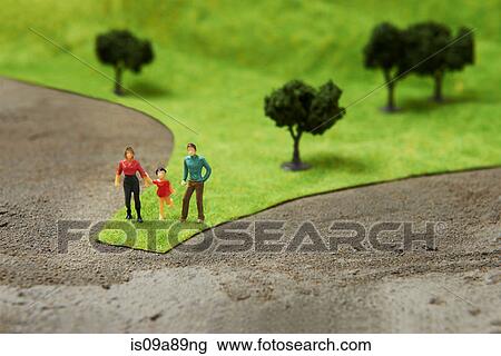 Stock Image - Figurines on pretend grass with trees. Fotosearch