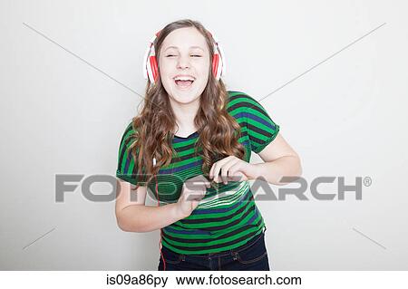 Girl dancing wearing headphones View Large Photo Image Stock Photo - Girl dancing wearing headphones. Fotosearch