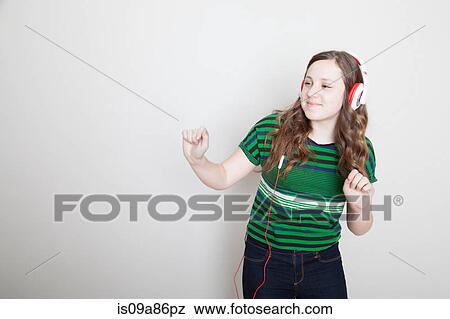 Girl dancing wearing headphones View Large Photo Image Stock Photo - Girl dancing wearing headphones. Fotosearch